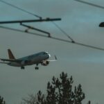 white and blue passenger plane flying during daytime